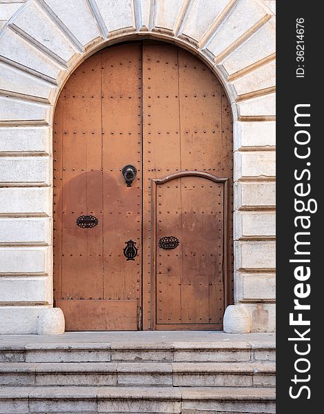 Nice arch metal door of ancient church with staircase. Nice arch metal door of ancient church with staircase