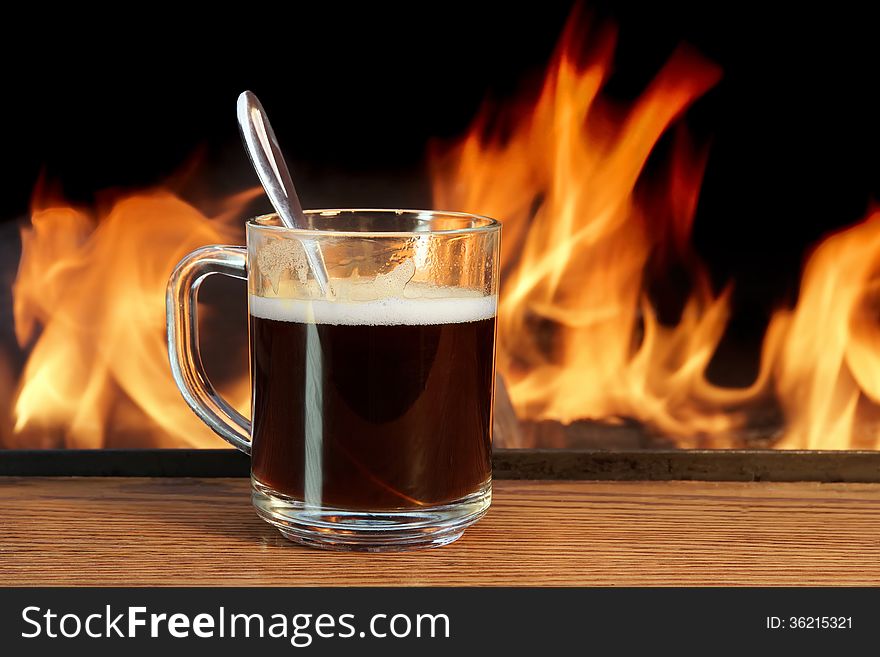 A Mug With Hot Coffee by the Fireplace. A Mug With Hot Coffee by the Fireplace
