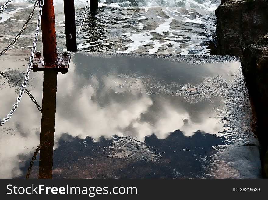 Clouds reflected in the wet steps down to the sea at Lyme Regis, Dorset. Clouds reflected in the wet steps down to the sea at Lyme Regis, Dorset