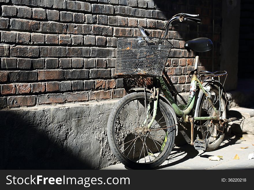 An old bike on the background of a wall