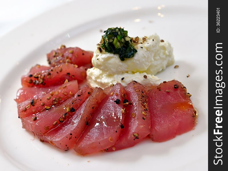 Tuna carpaccio with cheese garlic and basil