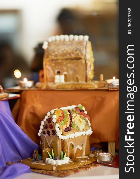 Beautifully decorated gingerbread houses with candles