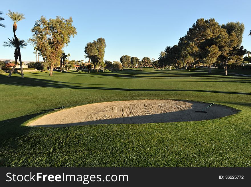 Sand trap in the fairway during sunset