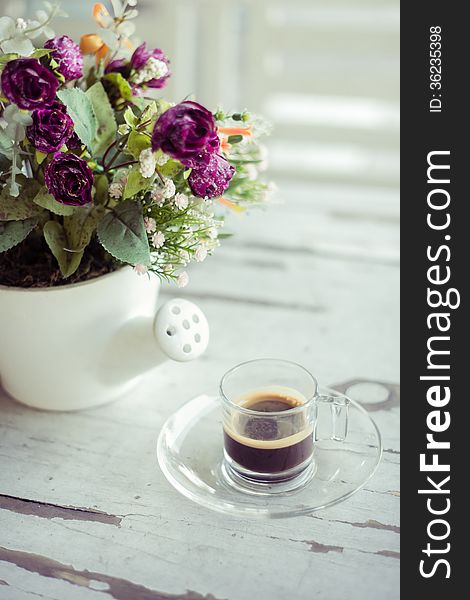 Cup of coffee with flowers on vintage table