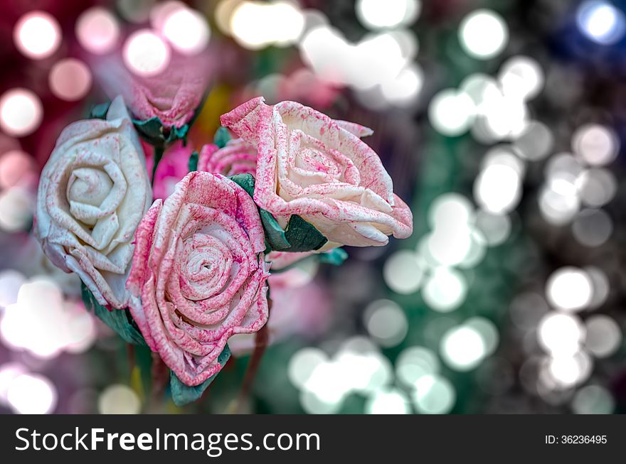 Artificial pink rose flowers on beautiful bokeh lights background