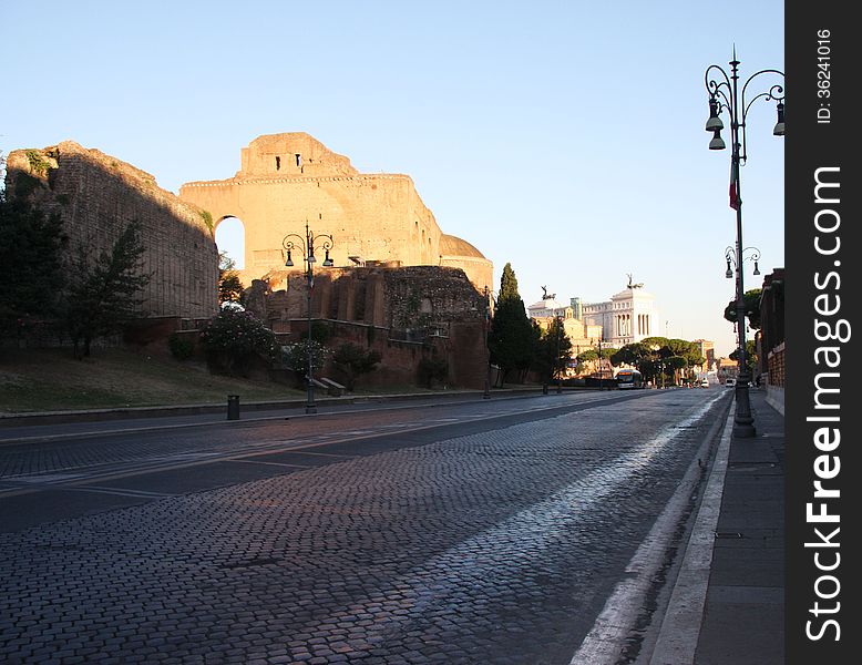 An early morning street view of a roman street heading towards the Vittoriano in the background. An early morning street view of a roman street heading towards the Vittoriano in the background