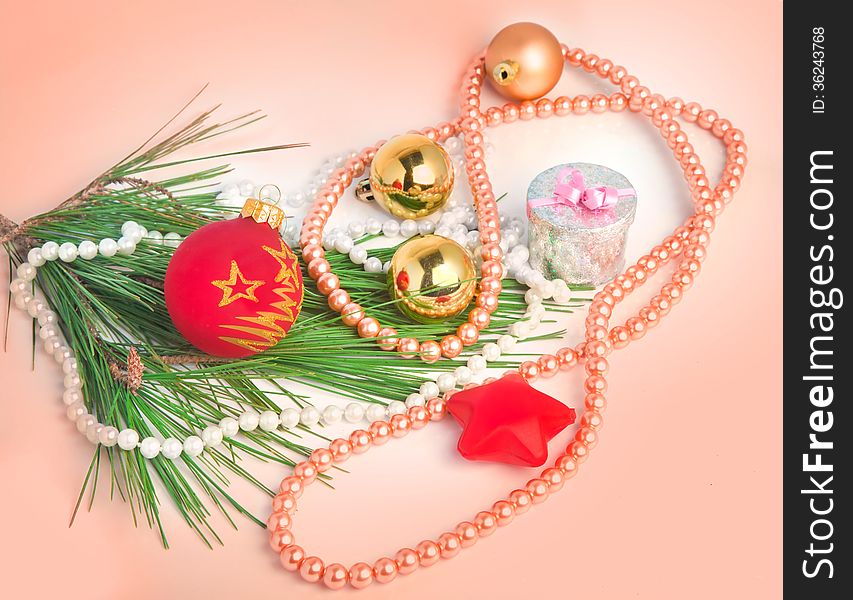 Peach color Christmas background with various Christmas tree decorations