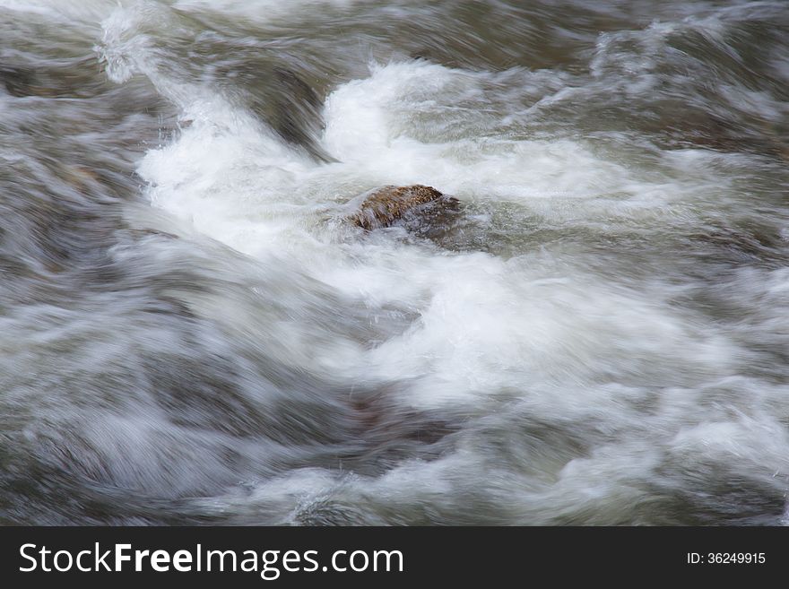 Water streams flowing from the mountains in streams with rocks.