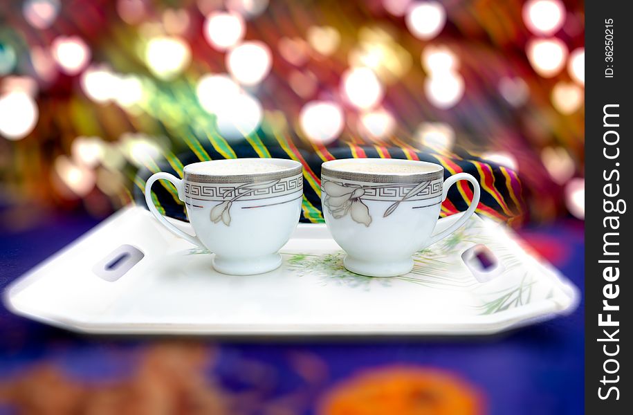 Coffee or tea cups on abstract bokeh light background