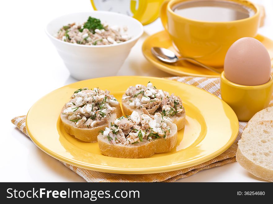 Breakfast - toasts with tuna and homemade cheese, coffee with milk and egg, isolated