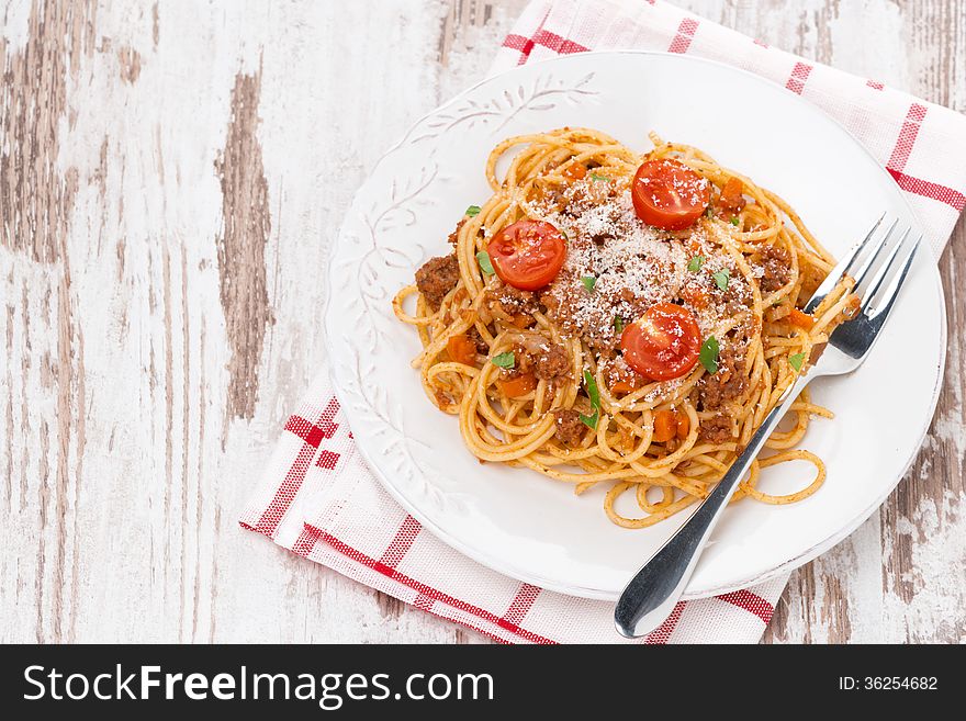 A plate of spaghetti bolognese on wooden table