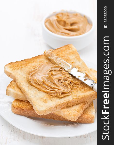 Toast with peanut butter, vertical, close-up