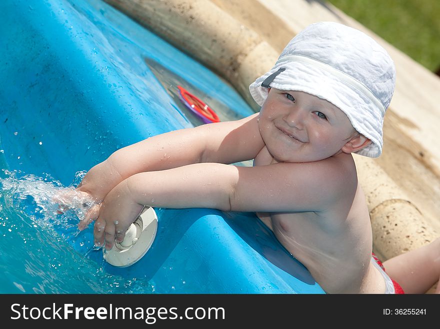 Cute toddler by a swimming pool. Cute toddler by a swimming pool