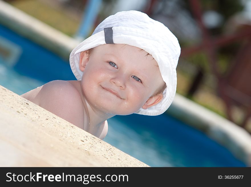 Cute toddler by a swimming pool. Cute toddler by a swimming pool