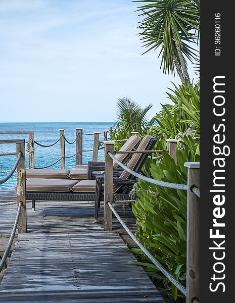 A view of the Caribbean sea with a boardwalk in the foreground. A view of the Caribbean sea with a boardwalk in the foreground.