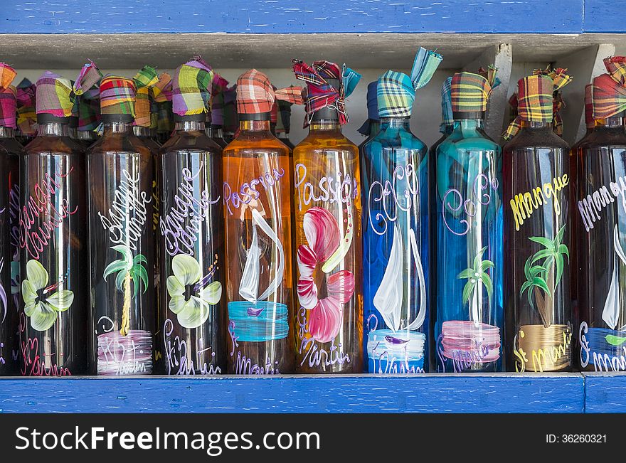 Row of colorful bottles filled with mixed island rum drinks. Row of colorful bottles filled with mixed island rum drinks.