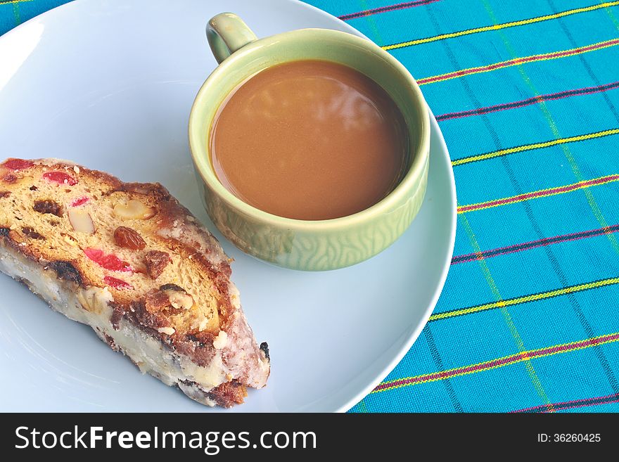 Fruitcake with raisin and Seasoning on table, with hot coffee. Fruitcake with raisin and Seasoning on table, with hot coffee