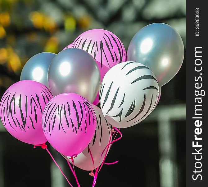 Pink and white zebra balloons at breast cancer awareness event