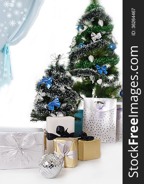 Christmas Tree Decorated With Blue Ornaments And Presents