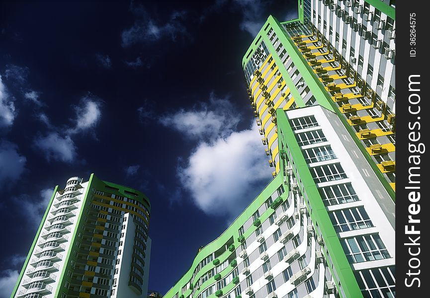 Fragment of modern condominium against a dark blue sky. Fragment of modern condominium against a dark blue sky.