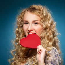 Girl Bites Heart. Concept Of Valentine S Day. Royalty Free Stock Images Girl Bites Heart. Concept Of Valentine S Day. Royalty Free Stock Images