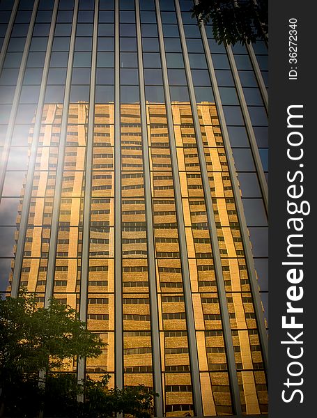 Old Stone Office Block Reflected In Modern Glass Skyscraper. Old Stone Office Block Reflected In Modern Glass Skyscraper