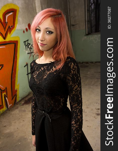 Beautiful young red haired model posing in abandoned buildings. Beautiful young red haired model posing in abandoned buildings