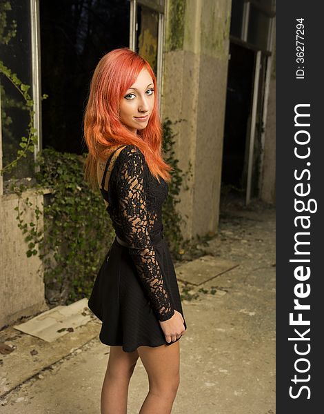 Beautiful young red haired model posing in abandoned buildings. Beautiful young red haired model posing in abandoned buildings