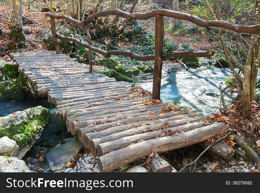 Wooden bridge over a mountain river in the forest