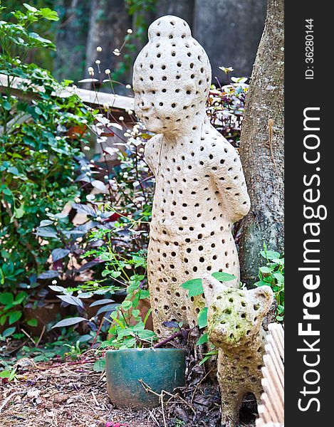 The white pottery with spot in child and dog design in Thai style for decorate in the garden