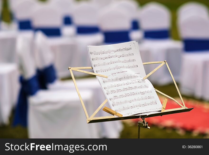 Notes of song in front of outdoor wedding ceremony place