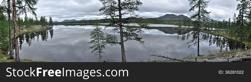 A panorama of lake mountains in the background, Suntar-khayata in Yakutia. District of Oymyakon highlands. A panorama of lake mountains in the background, Suntar-khayata in Yakutia. District of Oymyakon highlands.