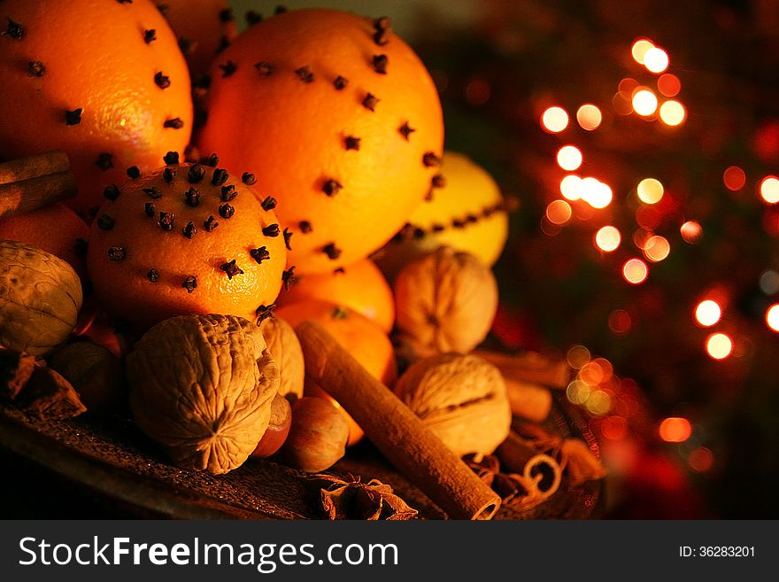 Christmas orange with cloves, fire lights on a background