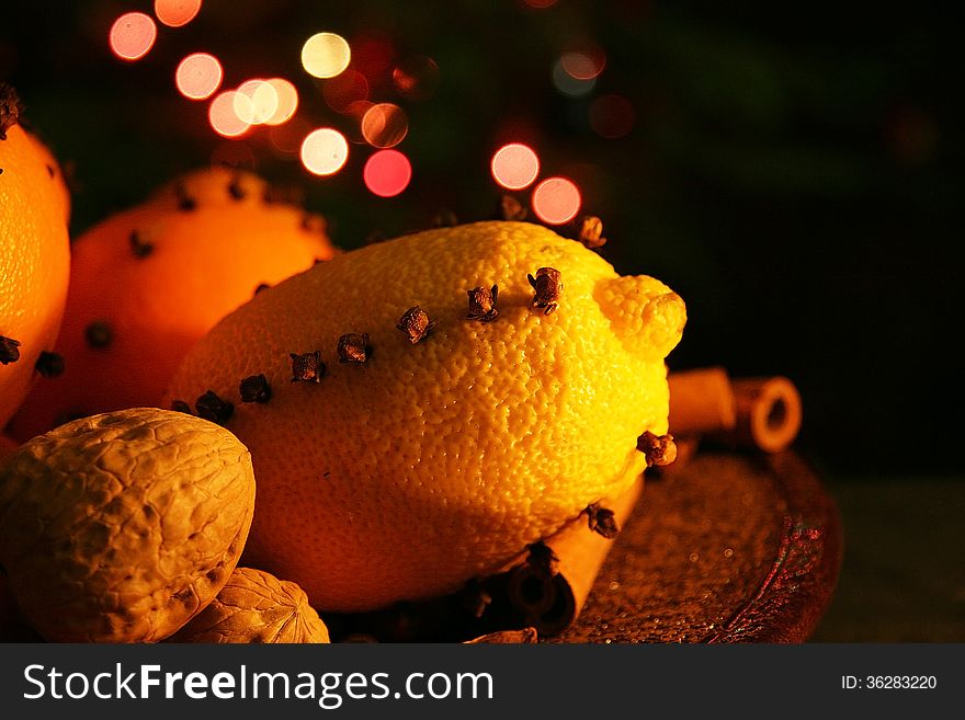 Christmas orange with cloves, fire lights on a background. Christmas orange with cloves, fire lights on a background
