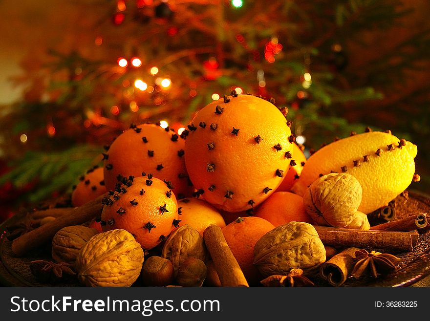 Christmas orange with cloves, fire lights on a background