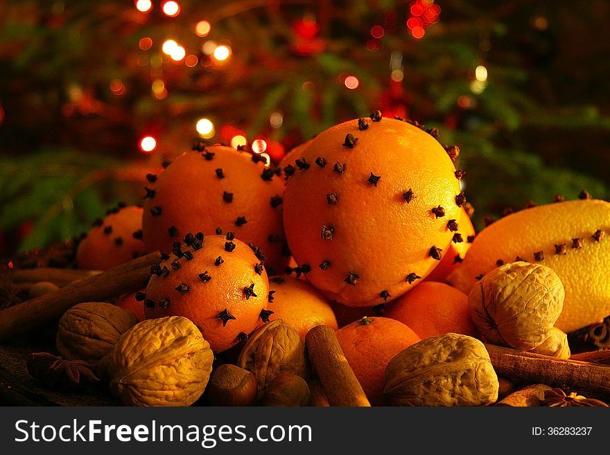 Christmas orange with cloves, fire lights on a background