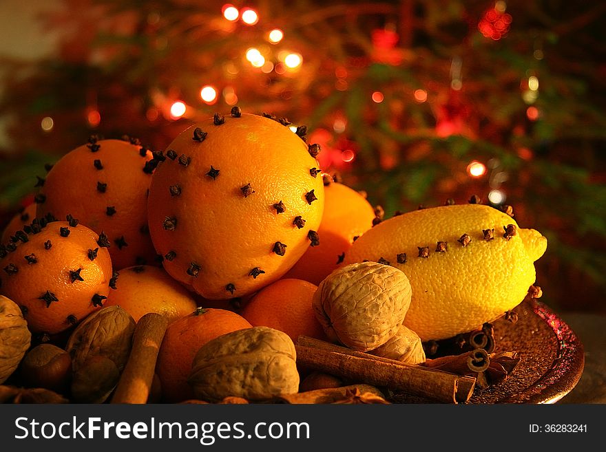 Christmas orange with cloves, fire lights on a background