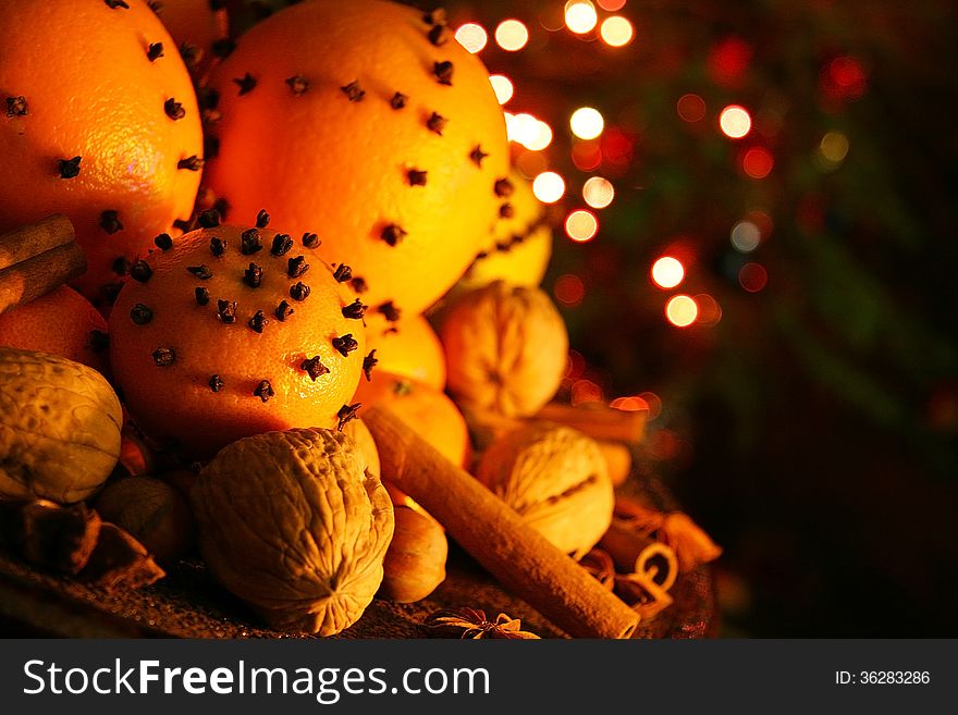 Christmas orange with cloves, fire lights on a background