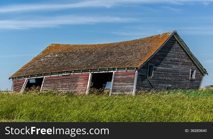 Leaning shed in a farm field