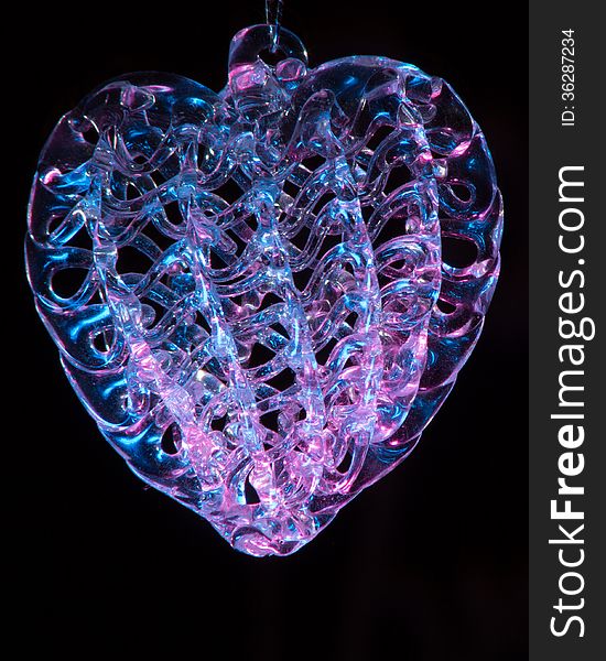 Intriquite crystal heart with multicolor facets. Stunning reflections in glass. Intriquite crystal heart with multicolor facets. Stunning reflections in glass