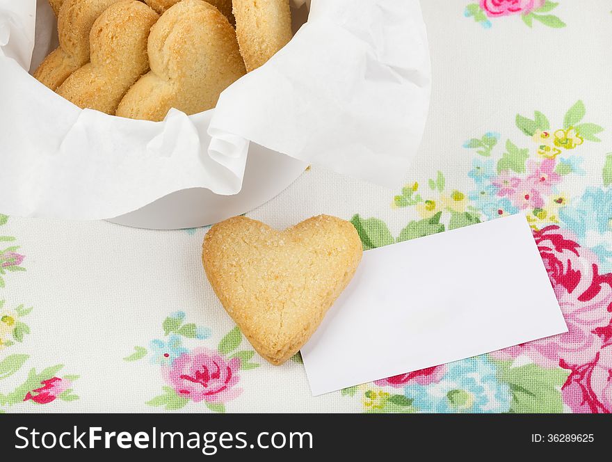 Heart shaped cookies with business card on the colorful background. Heart shaped cookies with business card on the colorful background