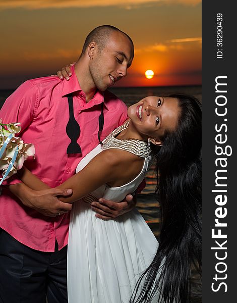 Portrait of bride and groom at sunset on sea