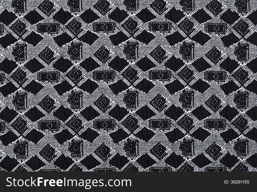 Material in geometric patterns, a grey textile background.