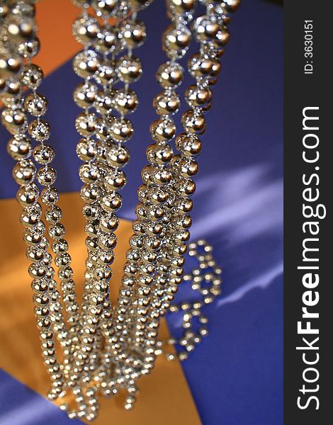 Bright beads against the blue and orange background