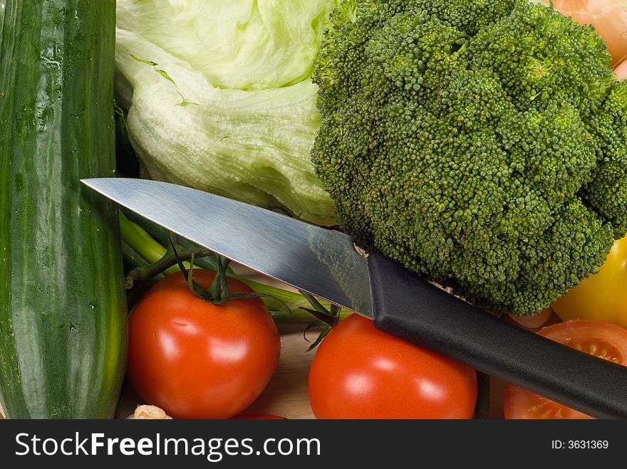 Cooking image of a knife and healthy vegetables. Cooking image of a knife and healthy vegetables