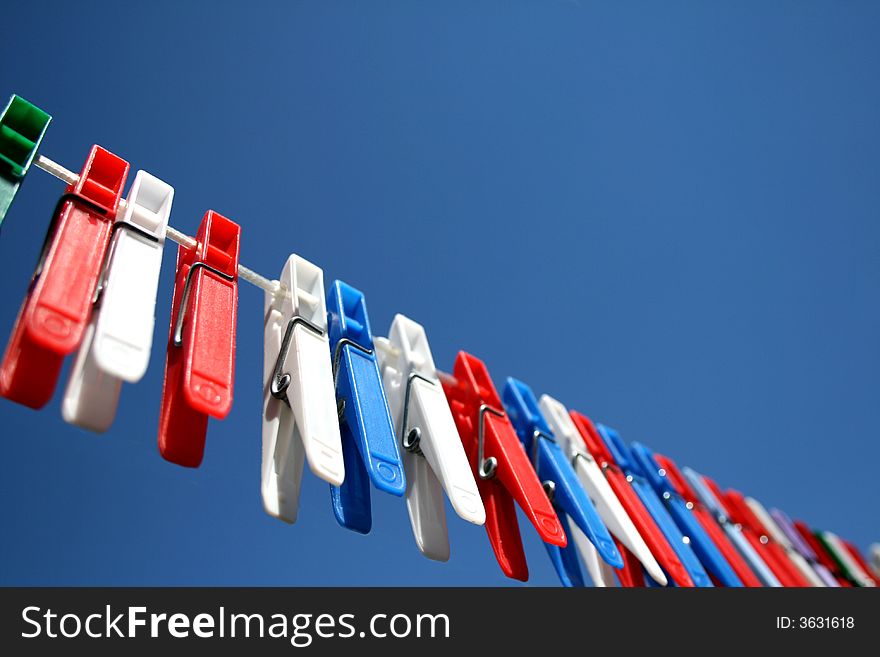 Clothesline with pegs on a sunny day. Clothesline with pegs on a sunny day