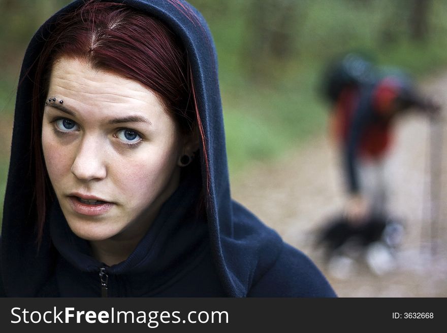 Thirsty girl hiking with a man and dog