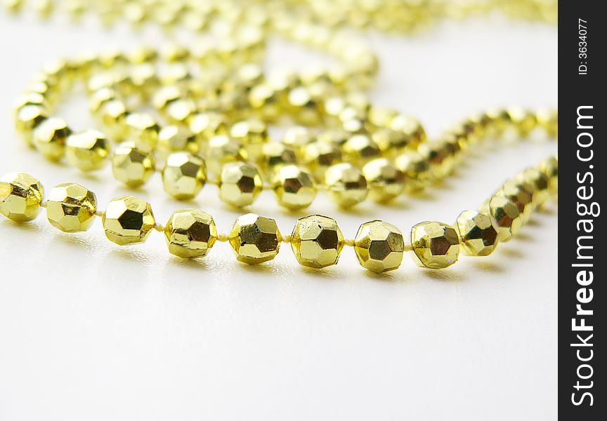 Gold beads on a white background