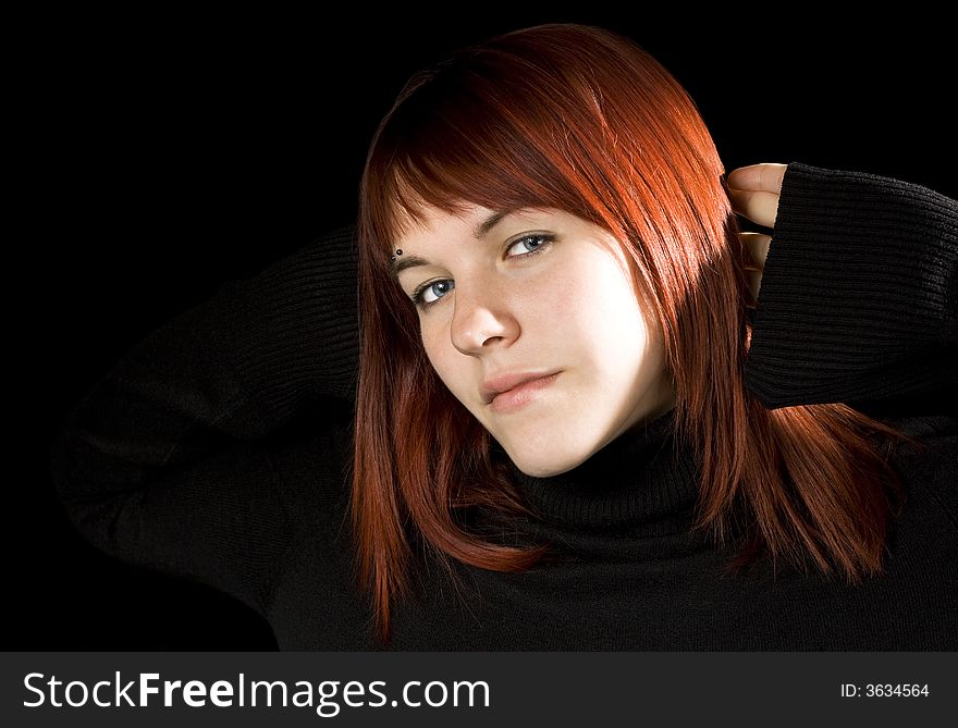 Red hair girl with hands behind head smiling, serene.

Shot in studio.