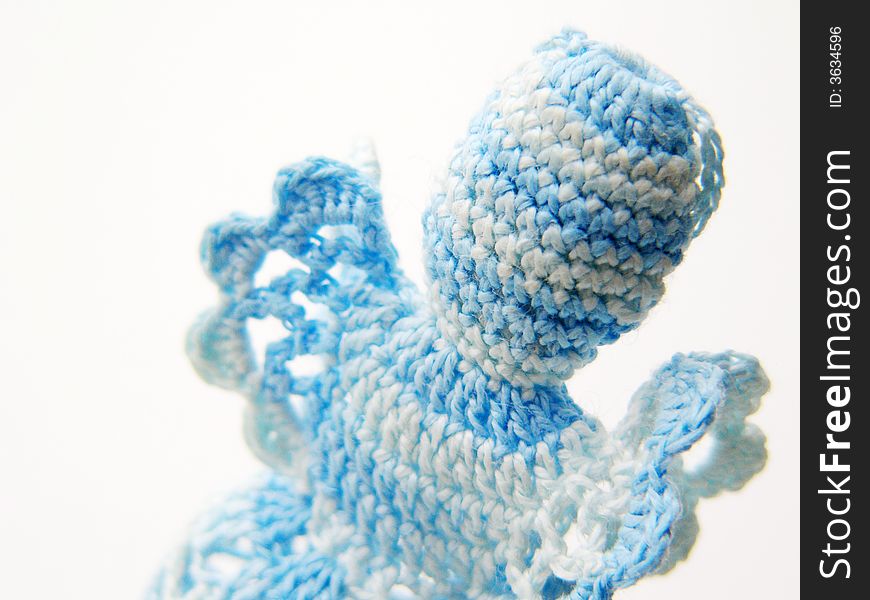 Detail of blue-white christmas crochet angel. Christmas decorations on a white background